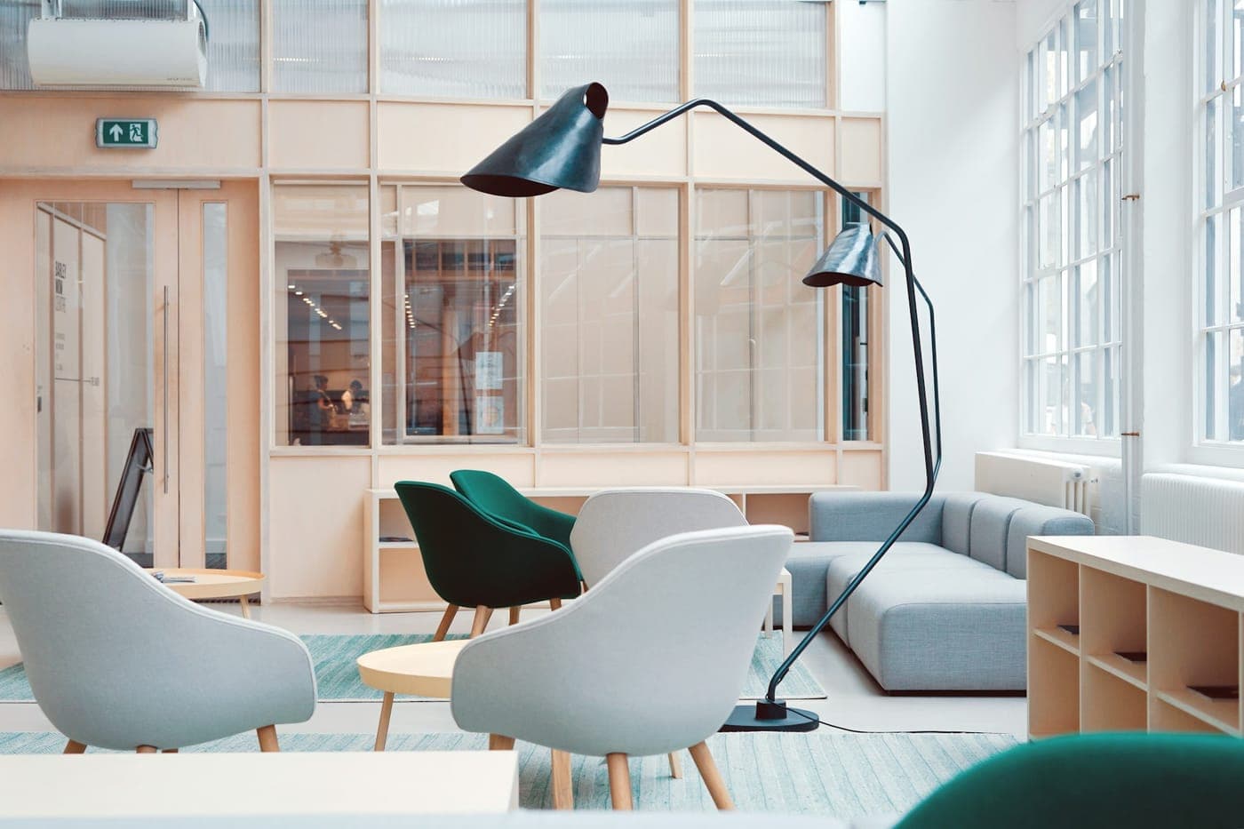 Light-filled studio interior with timber partitions and lounge chairs